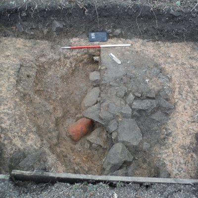 A large circular pit excavated in Trench 10 that was found to contain a number of large cobbles as well as a large lump of red ochre. © Copyright ARS Ltd 2018