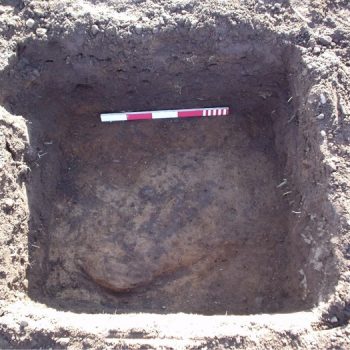 An example of a test pit excavated through the ploughsoil at Lanton Quarry revealing part of a buried pit feature. © Copyright ARS Ltd 2018