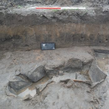 Two inter-cutting Bronze Age cists found within a trench in Fisheries Field (scale = 1m).