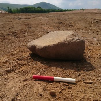 Fragment of broken quern stone (scale = 10cm).