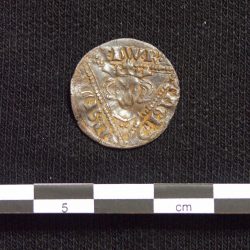 One side of the silver penny from Edward I's reign found during fieldwalking (scale = 5cm). © Copyright ARS Ltd