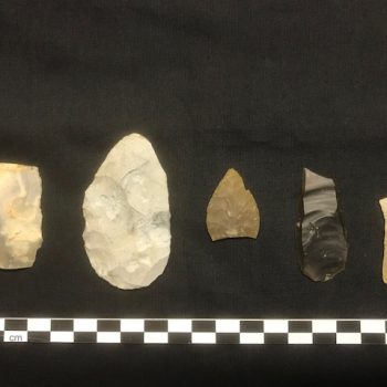 Neolithic flint tools found within the kettle hole, from left to right: a broken blade, a retouched burnt knife, a leaf-shaped arrowhead, a blade tool and a broken blade (scale = 20cm). © Copyright ARS Ltd
