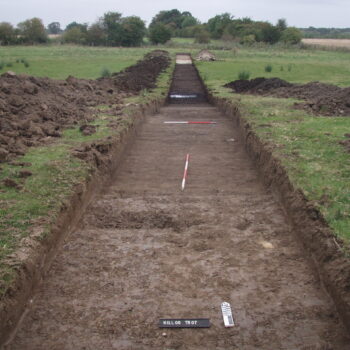 This trench, excavated as part of the 2009 evaluation, shows a dark peat deposit about halfway along its length. © Copyright ARS Ltd