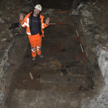 Archaeologist, Dimitrios, showing the flooring found during evaluation trenching of Lumford Mill © Copyright ARS Ltd