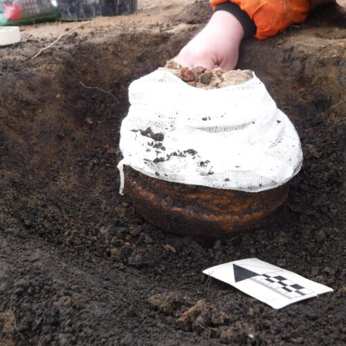 Collared Urn cremation during excavation.