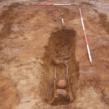 Decapitation burial with two skulls between legs