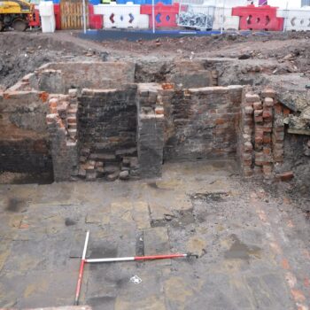 The remains of one of the cellars containing a fireplace in the back wall. © Copyright ARS Ltd