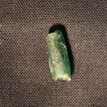 A Romano-British glass bead recovered from the Roman vicus at Hope Quarry.