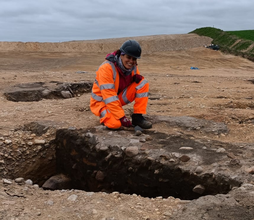 ARS Ltd Project Officer investigating a large midden pit on-site at Lochinver © Copyright ARS Ltd 2022