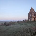 In this week’s #BuildingKnowledge we're looking at the Grade I Listed Penrith Beacon, situated on the summit of Beacon Hill. There is thought to have been a beacon on this site since the 13th century, with the current beacon constructed in 1719. The structure is built from red sandstone, with a pyramidal roof, and semi-circular arched apertures with keystones on each side, where the alerting fire would have been lit. The beacon would have been used to communicate the threat of impending attacks from Scottish raiders to the local population and wider settlements within the region. © ARS Ltd 2022