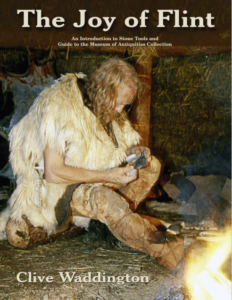 Front cover of joy of flint appearing to show early man working on flint