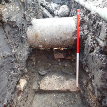 Westernmost section showing the northern face of Hadrian’s Wall exposed near the Two Ball Lonnen Roundabout beneath a metal water pipe. Scale = 0.5m gradations © ARS Ltd 2023