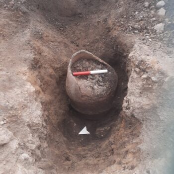 The inverted cremation urn once the fill of the pit containing it had been removed (scale = 20cm) © ARS Ltd 2025