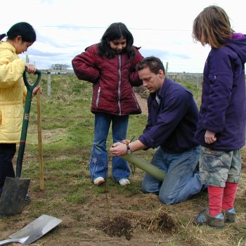 Clive Waddington helping local school children plant their own tree sapling on the site © ARS Ltd 2026