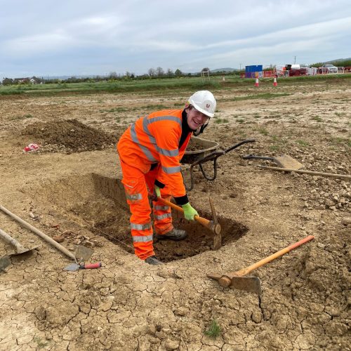 One of our team busy mattocking the fill of a ‘section’ across a ditch © ARS Ltd 2026